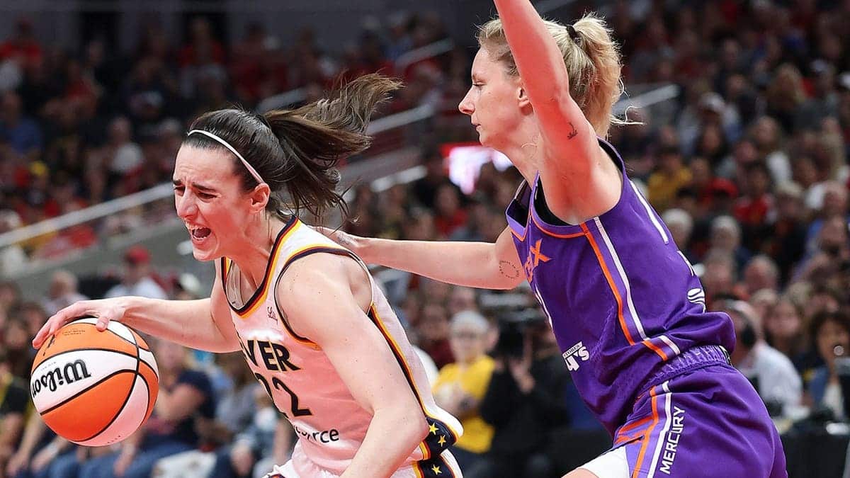 Caitlin Clark dribbling basketball defended by Lexi Held at Gainbridge Fieldhouse