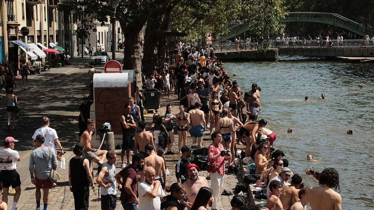 People swimming in Canal Saint-Martin in Paris, France.