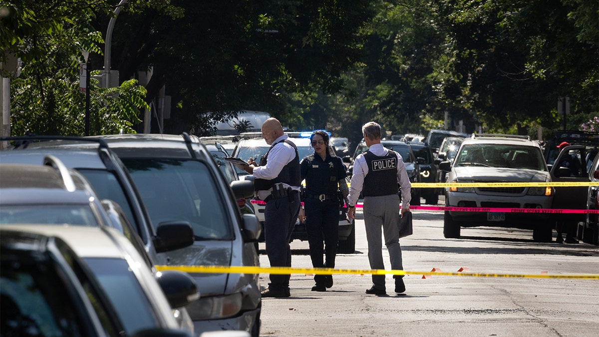 Chicago police officers investigating a drive-by shooting scene in Chicago Illinois