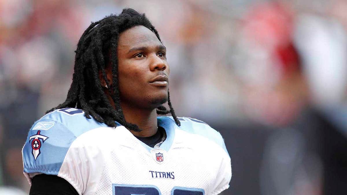 Chris Johnson standing on the sidelines during a football game at Reliant Stadium.