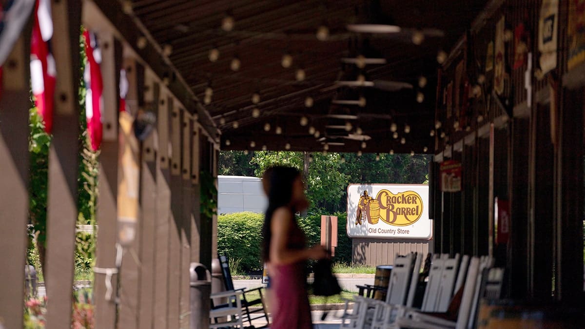 A Cracker Barrel Old Country Store customer walking on the patio toward the entrance in Dumfries, Virginia.