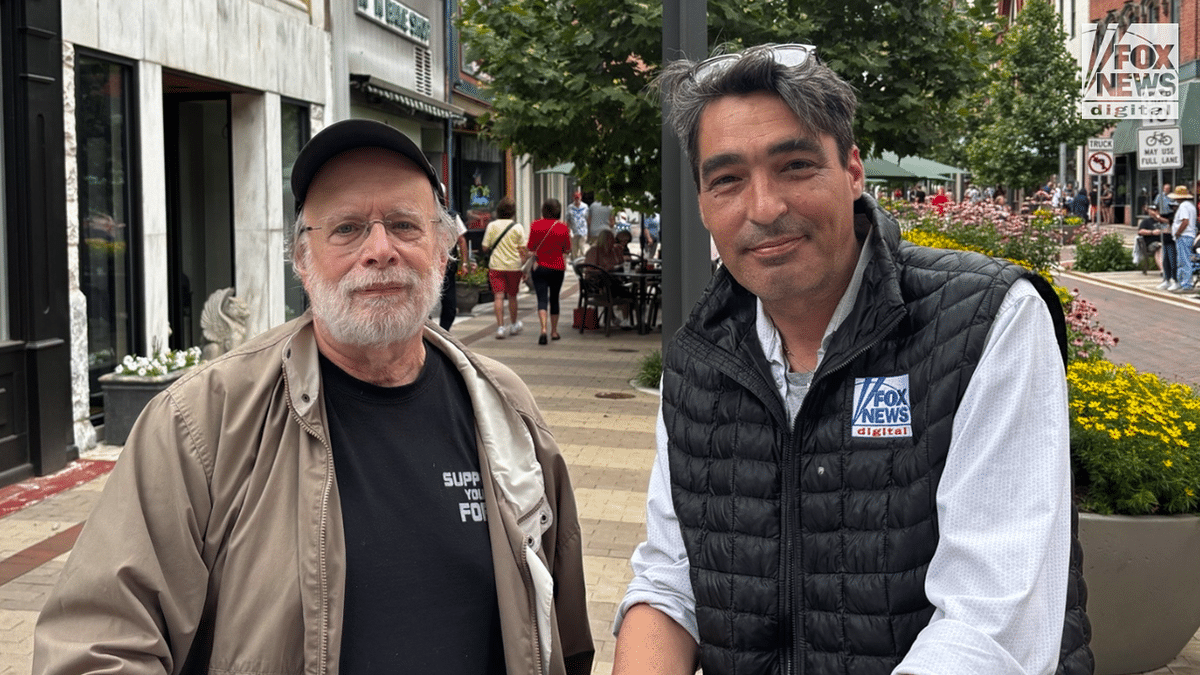 A Fox News Digital reporter and a parade attendee pose for a photo on a downtown Cumberland sidewalk during the America 250 celebration.