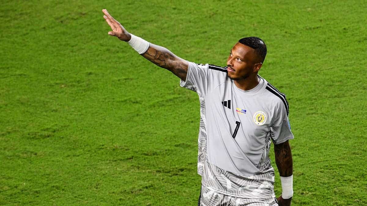 Curacao goalkeeper Eloy Room waving to fans on the soccer field.