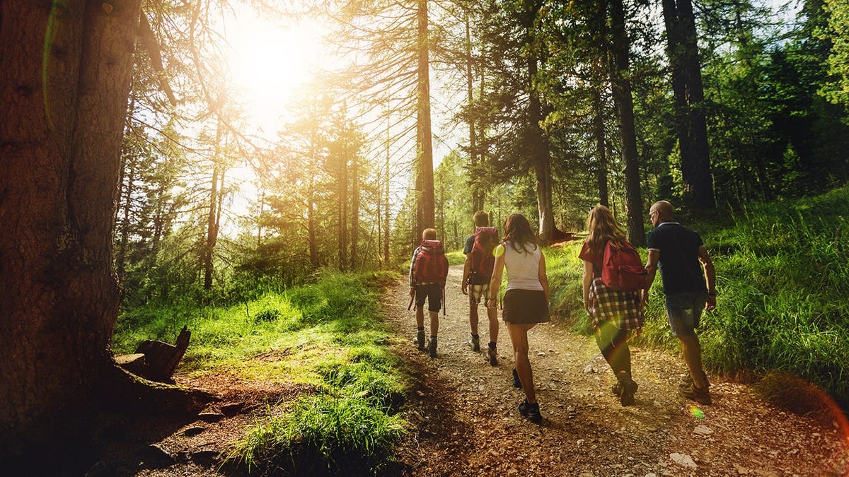 A family hiking together in the Dolomites mountains.