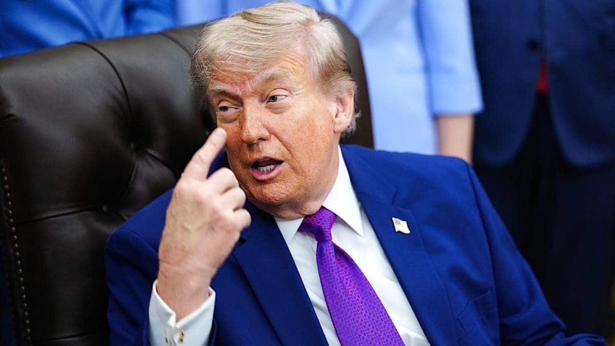 President Donald Trump points to his brain in the Oval Office