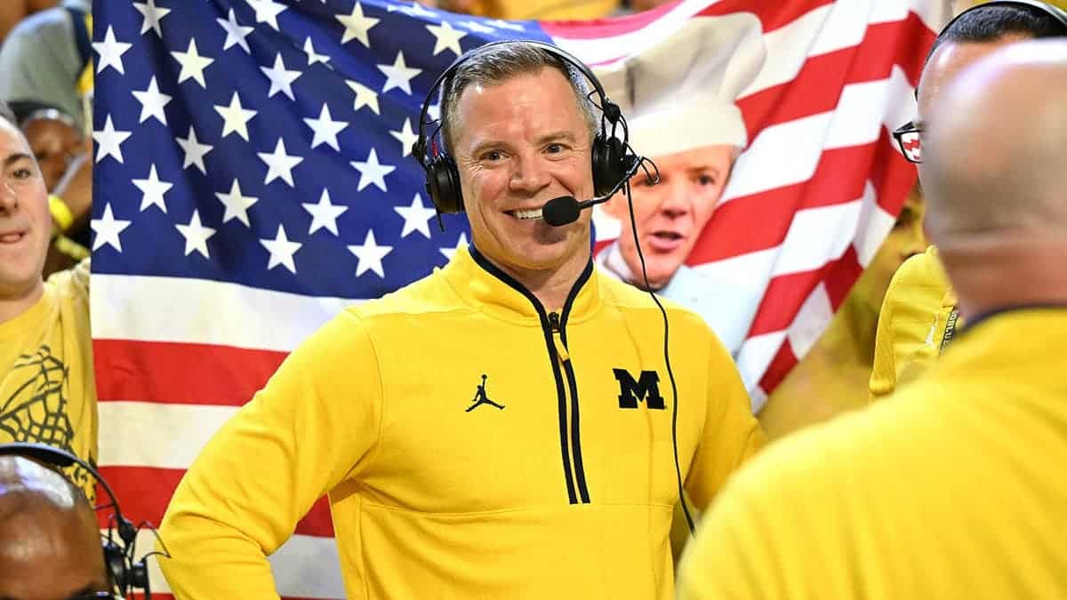 Michigan head coach Dusty May talking with media after basketball game.
