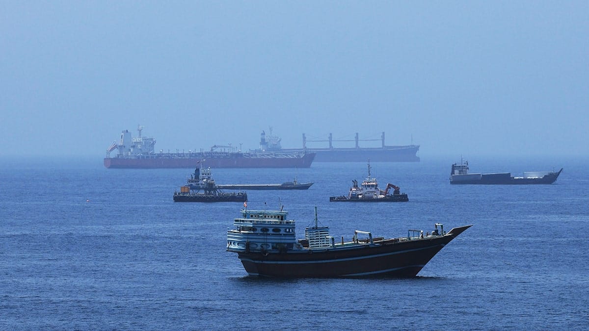 A view of commercial cargo vessels and crude oil tankers are anchored in the Gulf of Oman, off the coast of Muscat, Oman, on June 21, 2026, as they prepare to transit through the critical Strait of Hormuz