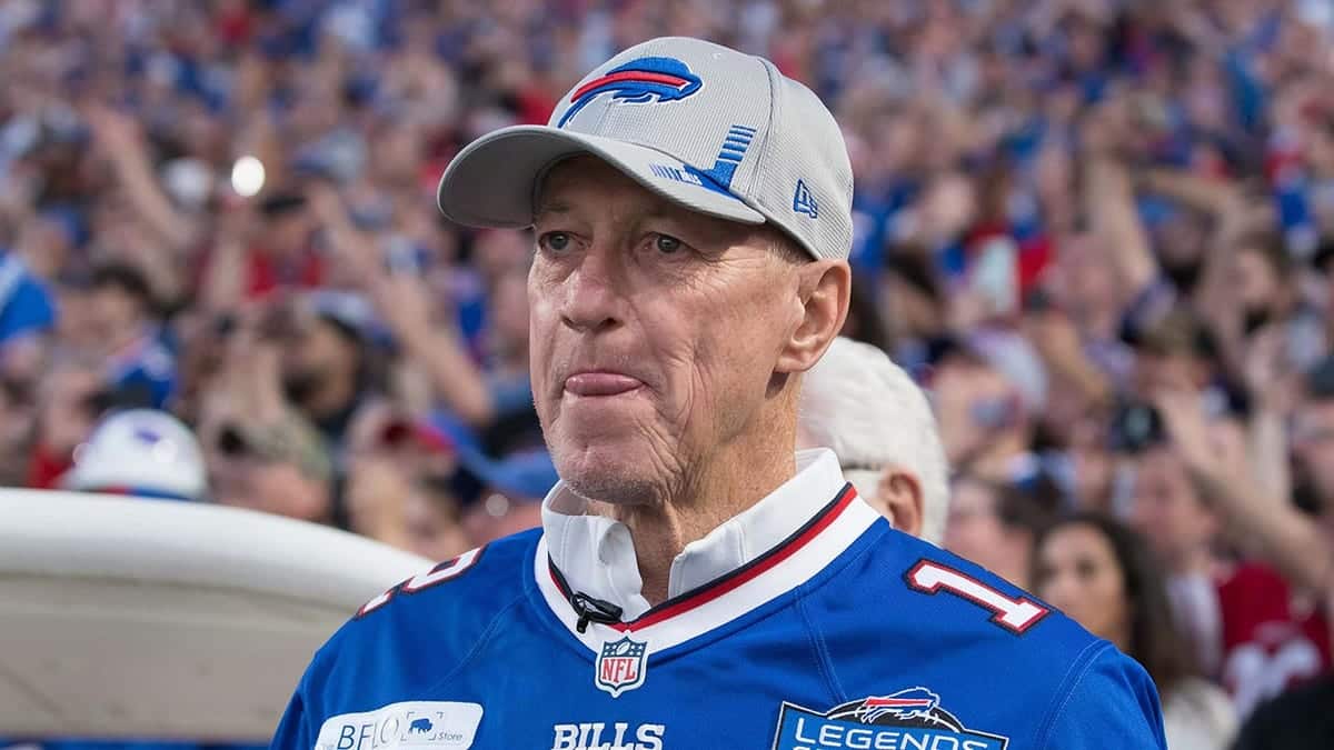 Jim Kelly standing on the field at Highmark Stadium before a game.