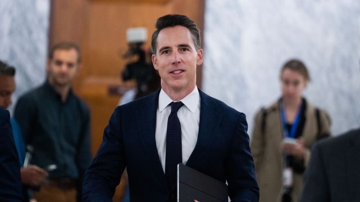 Sen. Josh Hawley walking to a Senate Judiciary Committee confirmation hearing in the Dirksen building