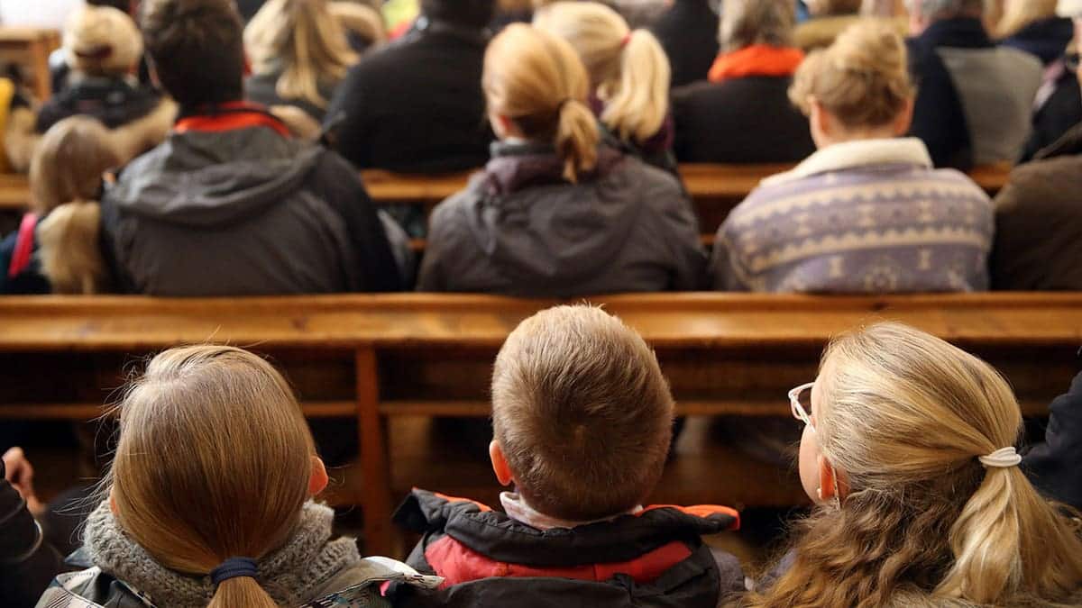 A Pennsylvania church interior with children and adults seated in pews