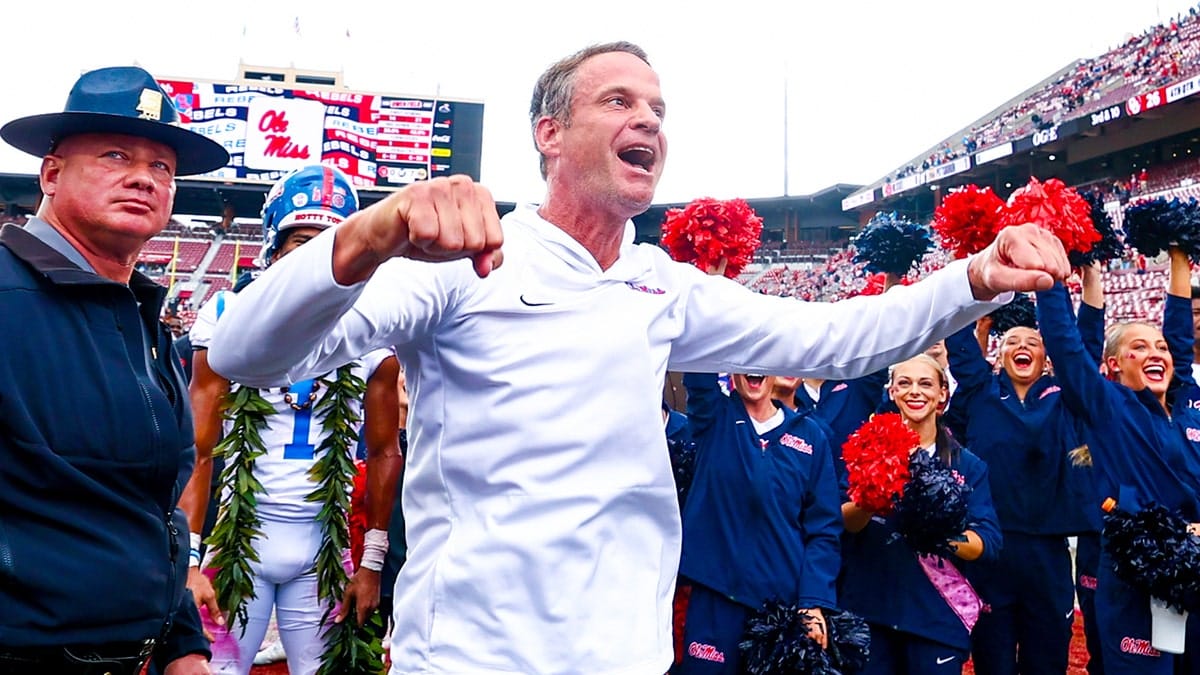 Ole Miss Rebels head coach Lane Kiffin celebrating with fans at Gaylord Family-Oklahoma Memorial Stadium