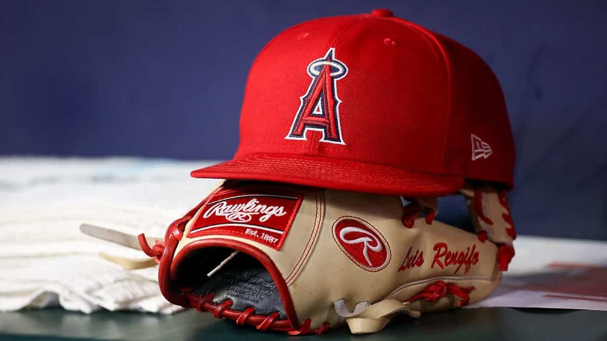 Los Angeles Angels hat and glove resting on a bench at Truist Park.