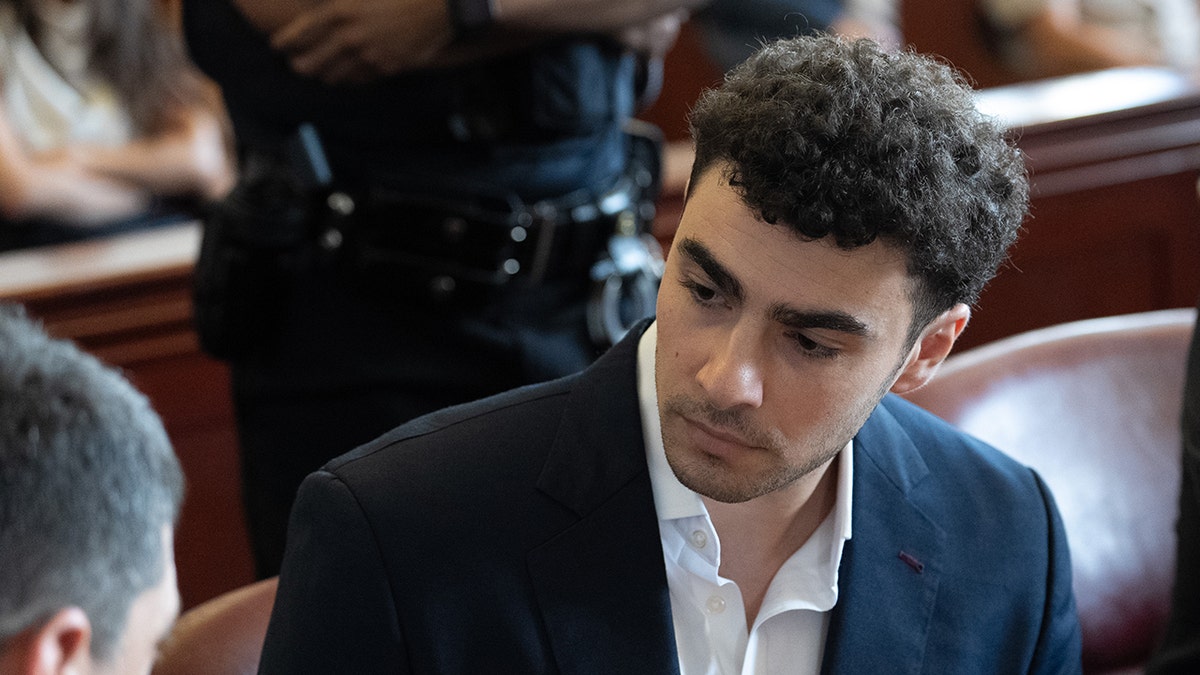 Luigi Magione standing in a courtroom during a pre-trial hearing in Manhattan Criminal Court New York