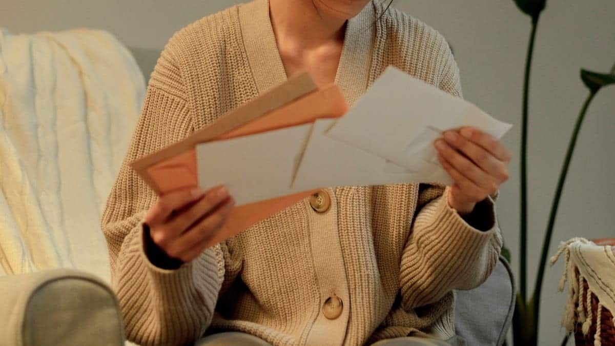 A person opening an envelope