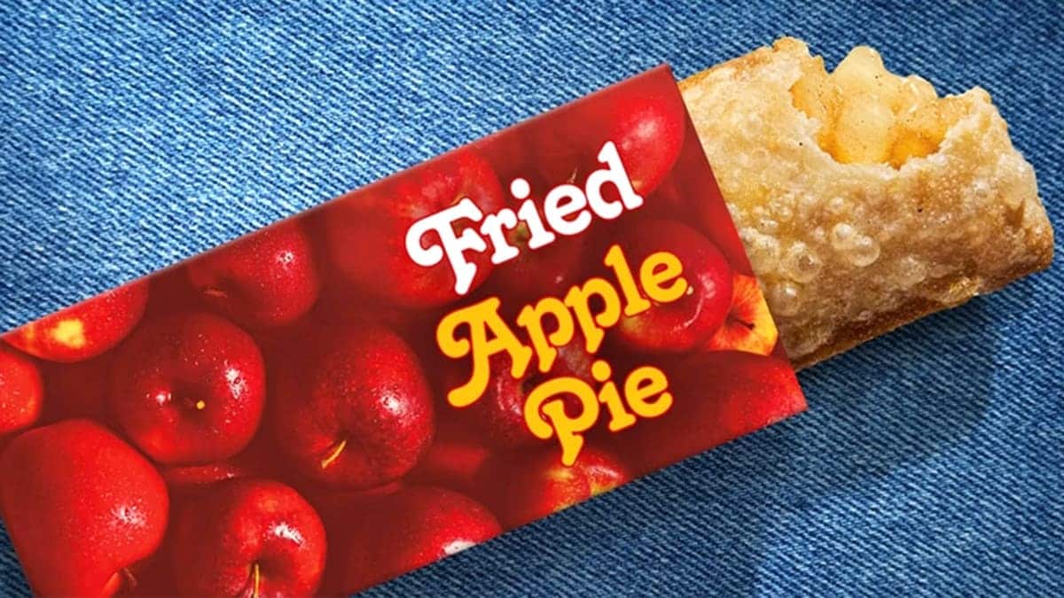 McDonald's fried apple pie partially removed from a red apple-themed sleeve.