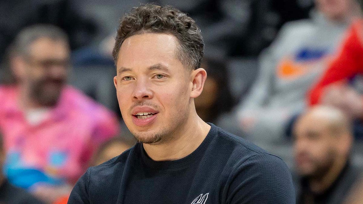 San Antonio Spurs assistant coach Mitch Johnson watching game from sidelines at Little Caesars Arena