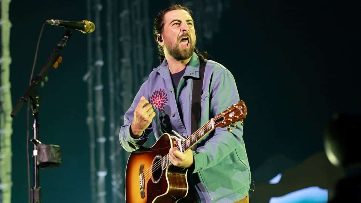 Noah Kahan sings on stage