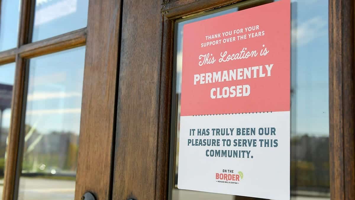 Sign reading 'permanently closed' outside On the Border Mexican Grill & Cantina in Greenville, South Carolina
