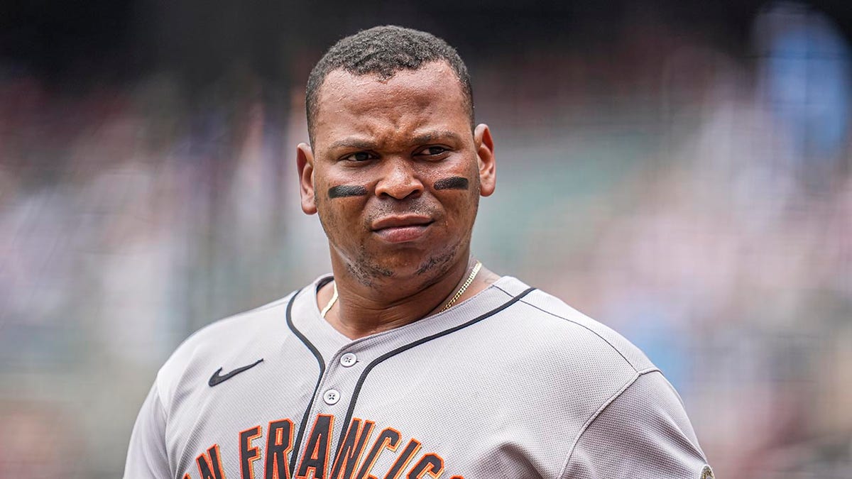 San Francisco Giants designated hitter Rafael Devers walking off the field at Truist Park.