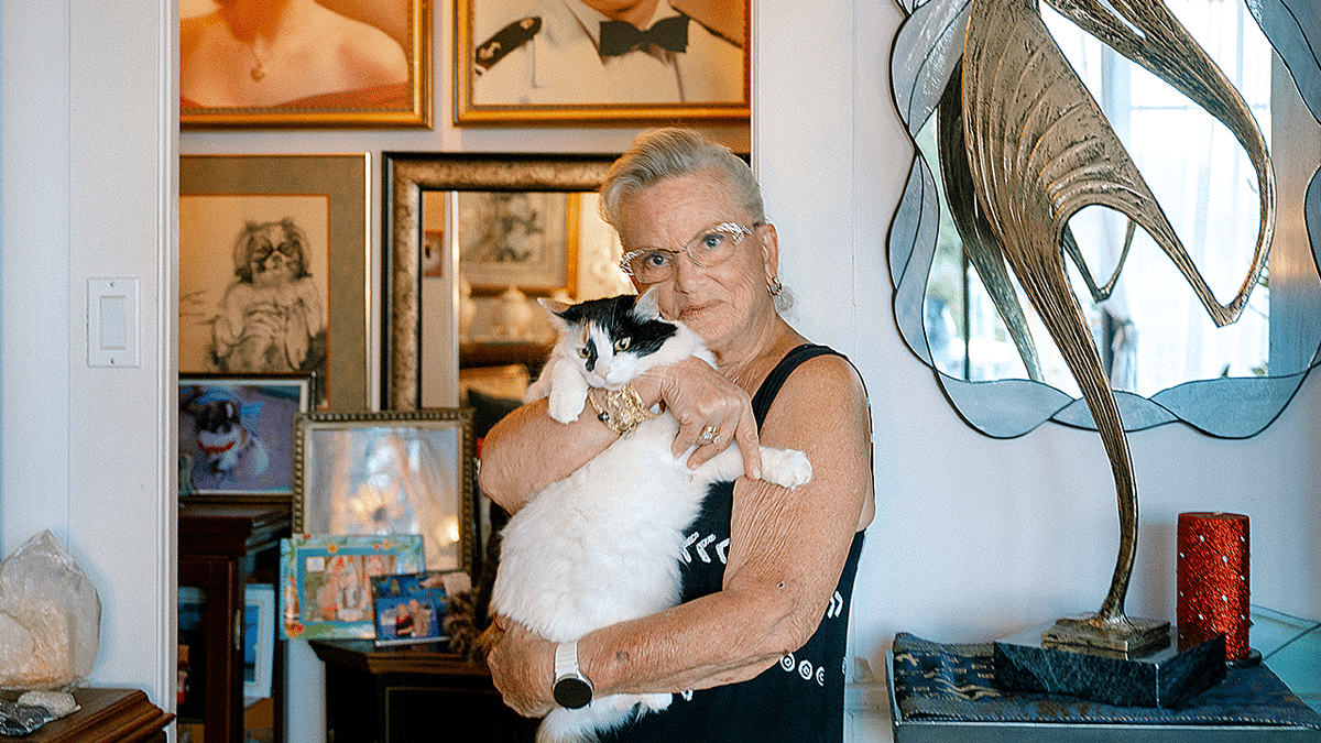 Sandra May cuddles her cat in home photo