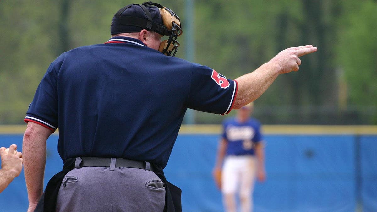 Softball umpire signaling strike two during a game