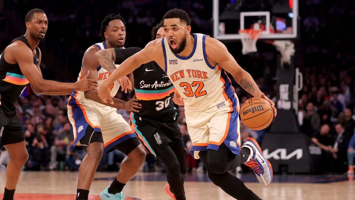 New York Knicks C Karl-Anthony Towns drives to the basket on San Antonio Spurs wing Julian Champagnie at Madison Square Garden.