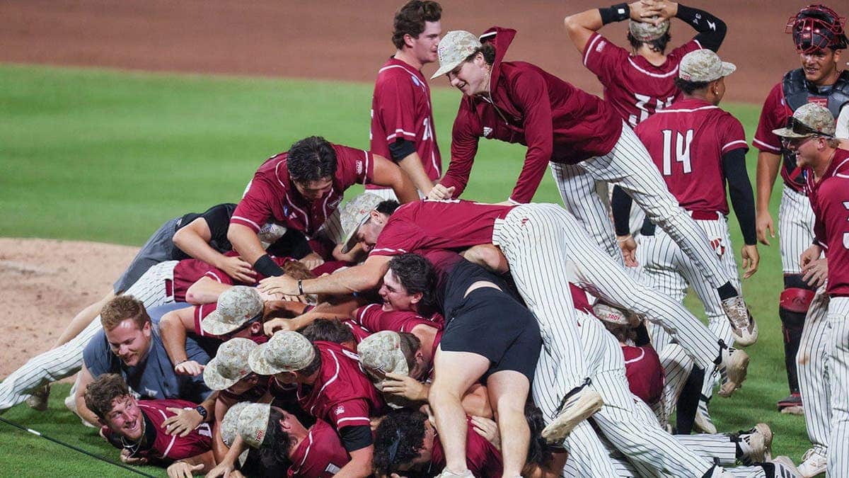 Troy baseball players celebrating on the field at Condron Family Ballpark