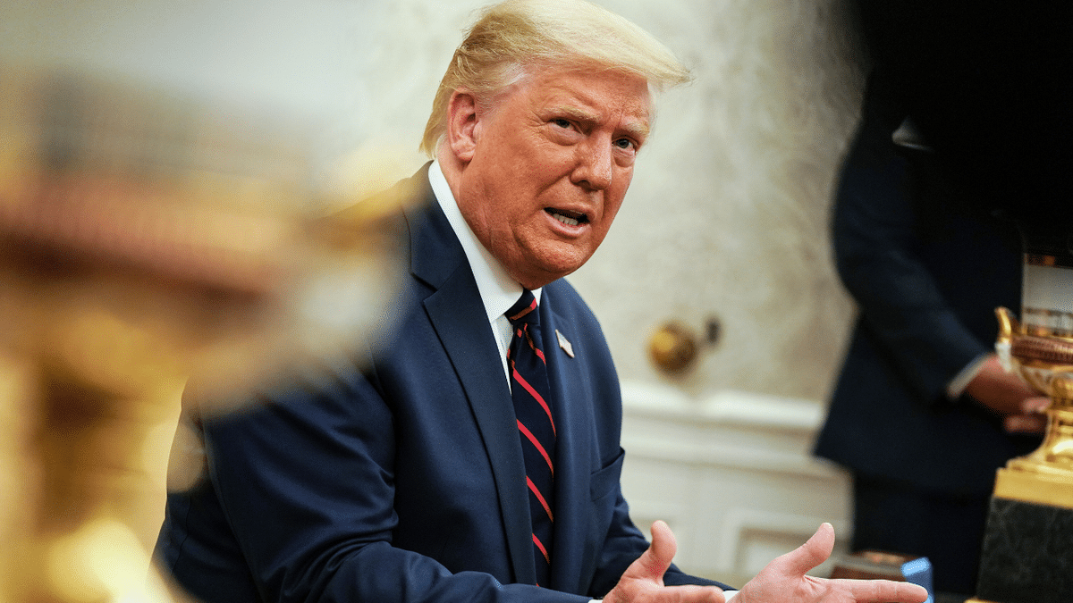 President Donald Trump talks to reporters during a meeting with Iraqi Prime Minister Mustafa Al-Kadhimi in the Oval Office at the White House.