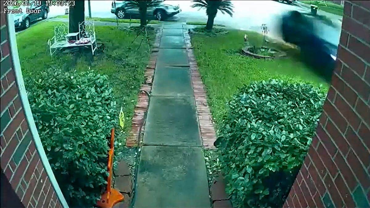 Surveillance footage of a car crashing into a house