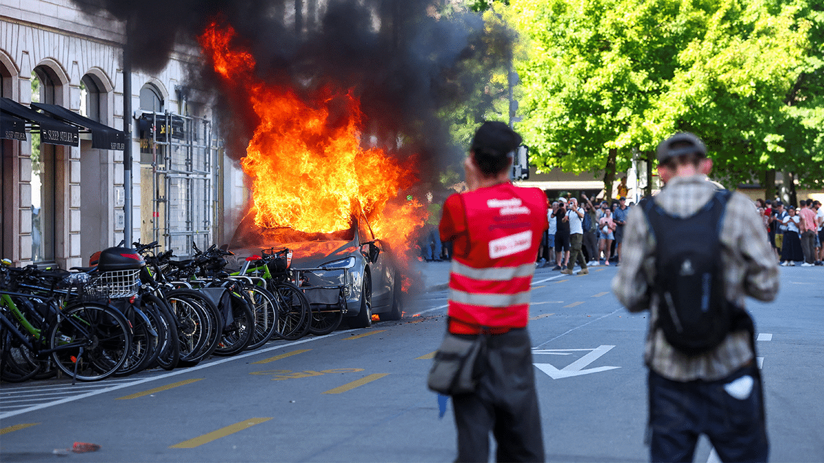 A Tesla car burns during a protest