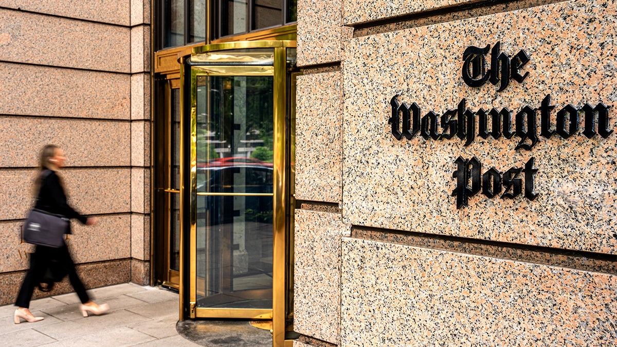The exterior of The Washington Post building is shown with its signage visible.