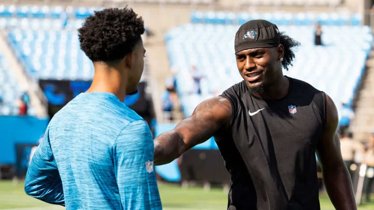 Xavier Legette and Bryce Young warming up on the field at Bank of America Stadium