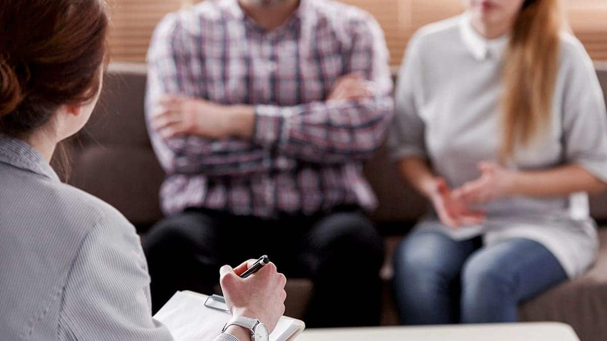 Couple sitting with therapist