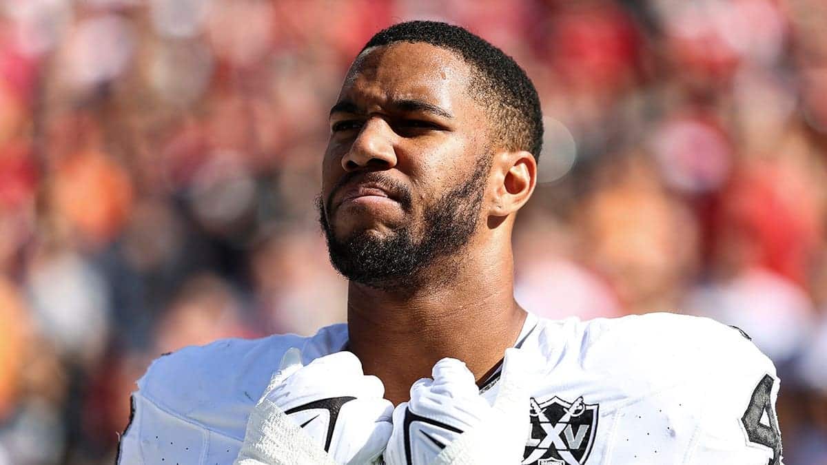 Charles Snowden stands on the sidelines during the national anthem.