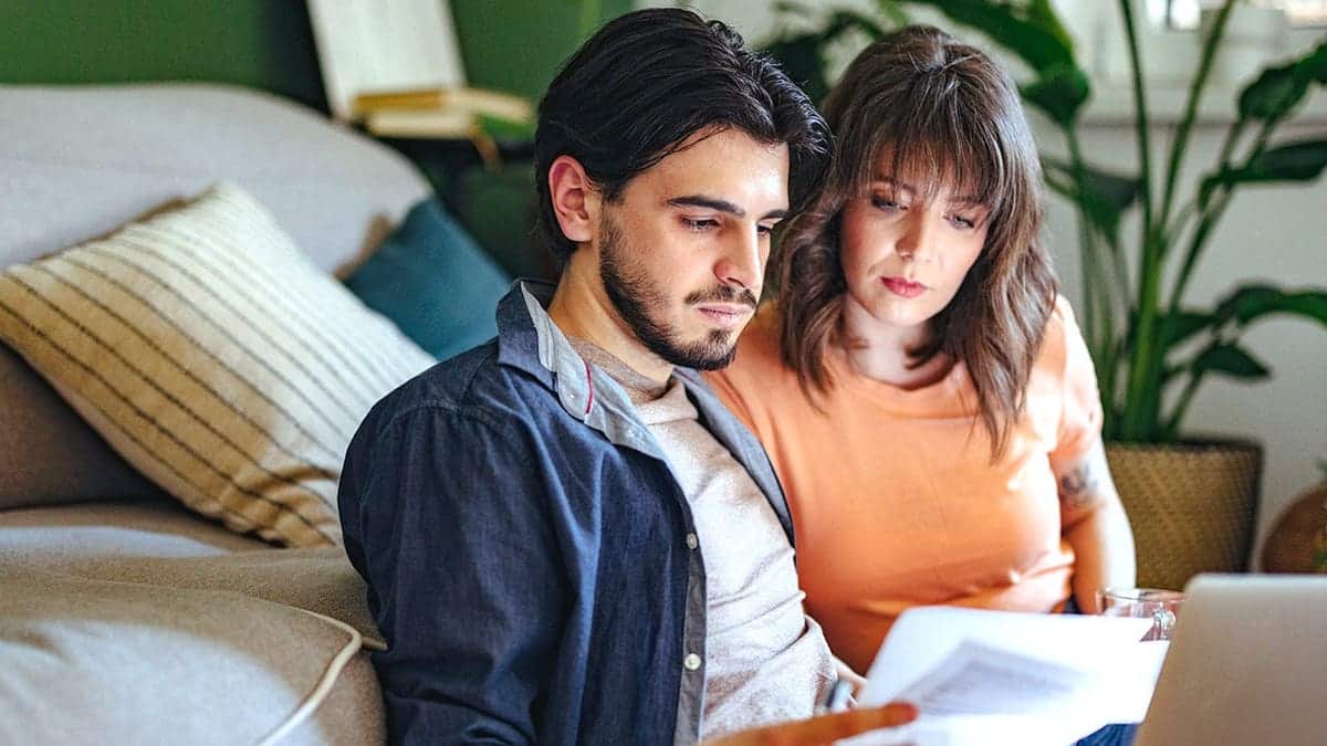 Concerned Couple Looks at Paperwork
