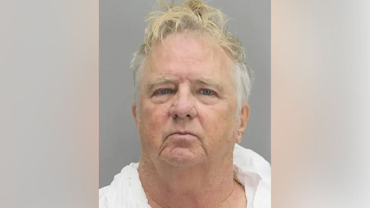 Mugshot of Leland Jameson, an older man with light hair and blue eyes wearing a white shirt, against a gray background.