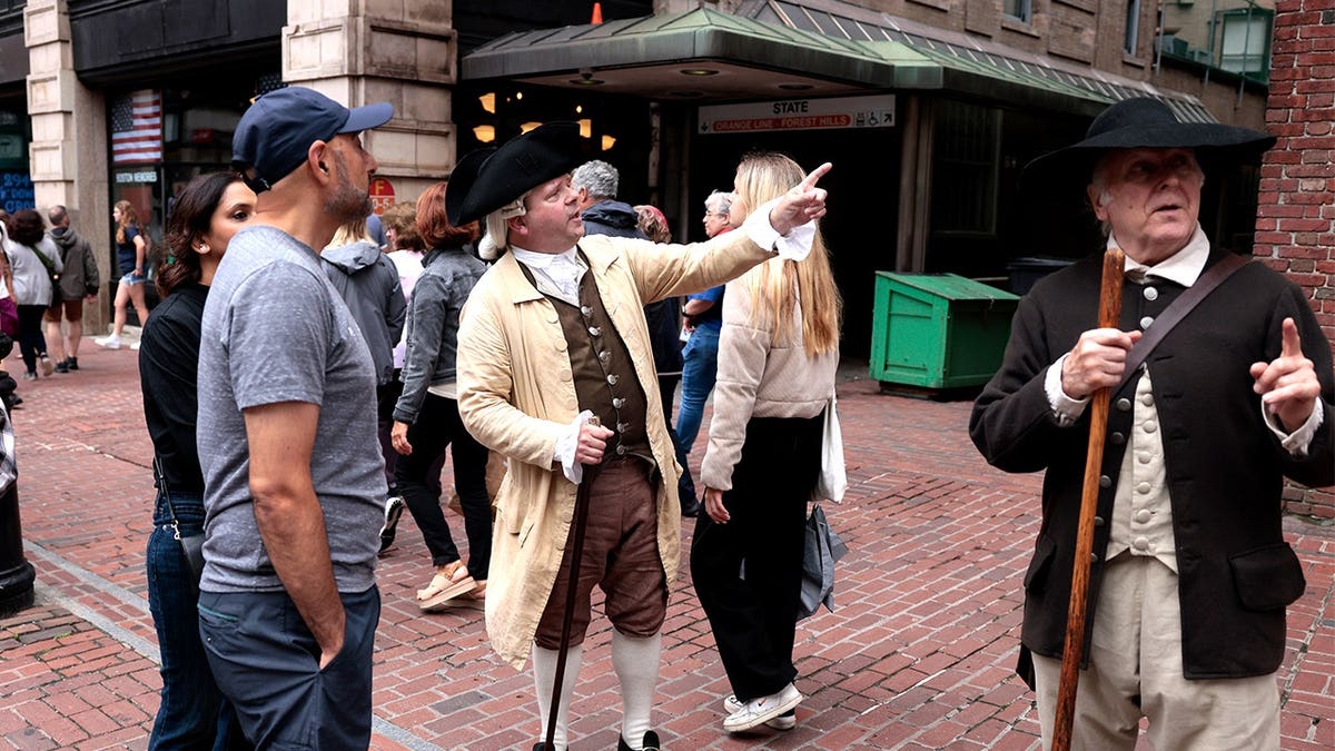 Colonial reenactors speaking to tourists