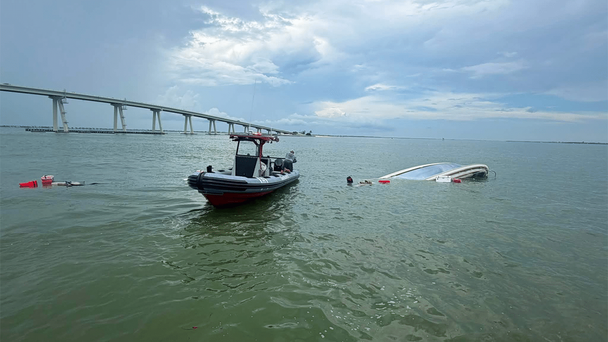 The U.S. Coast Guard shared photos of the boat nearly completely under water following the swift rescue.