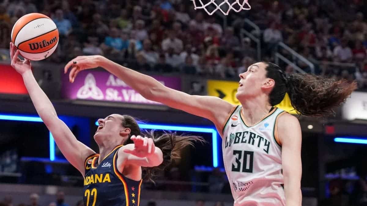 Caitlin Clark shoots against Breanna Stewart at Gainbridge Fieldhouse.