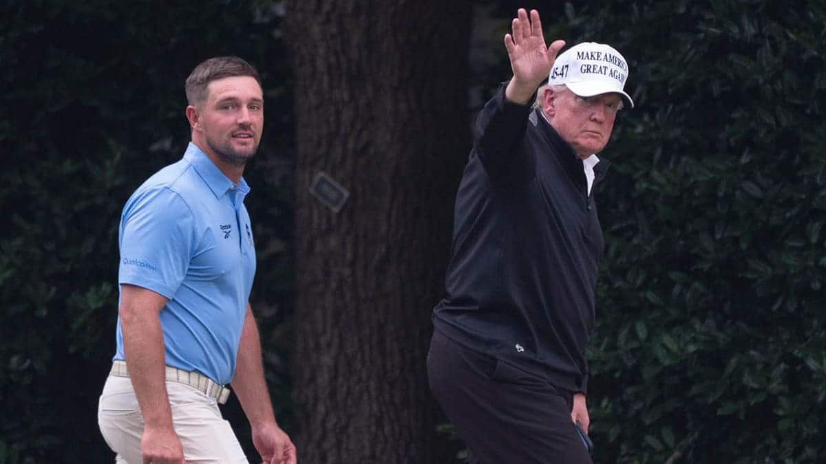 Donald Trump waves to reporters