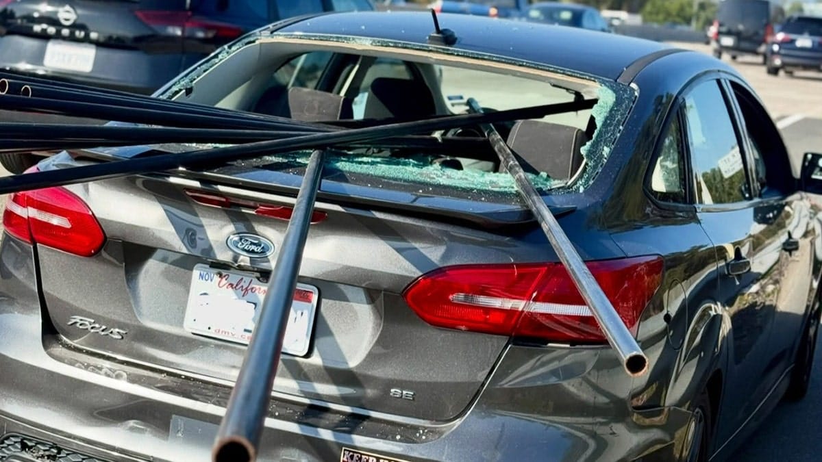 Metal pipes pierce car window