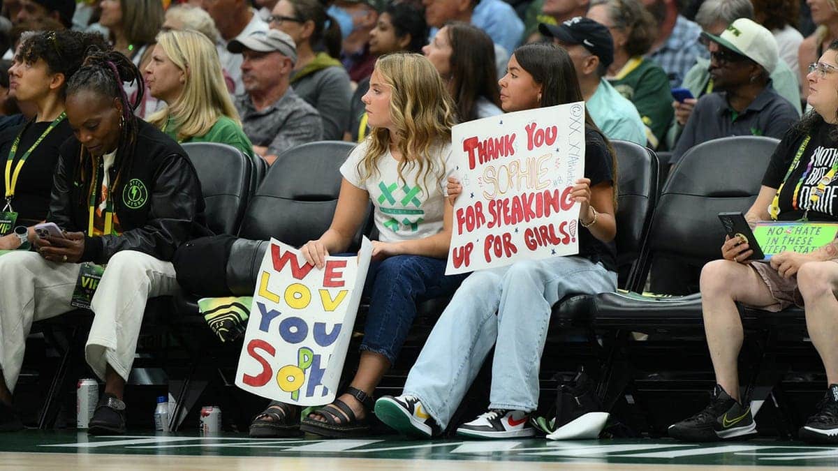 Fan holds a Sophie Cunningham sign during the first half at Climate Pledge Arena.