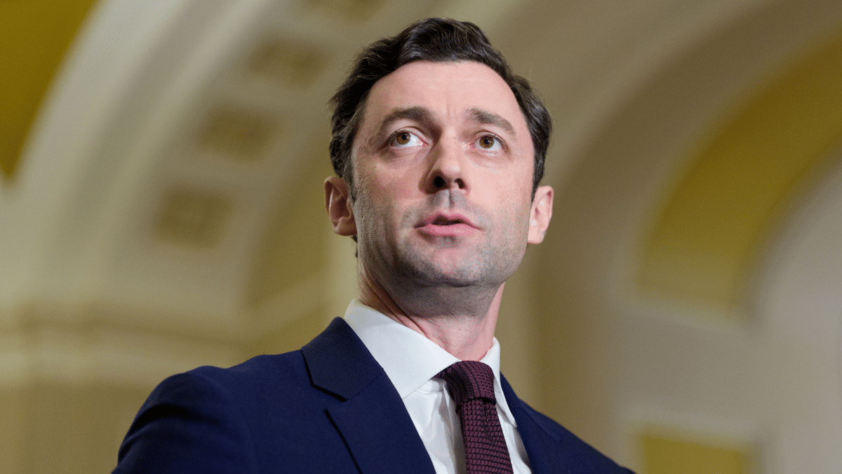 Democrat Senator Jon Ossoff listens to a news conference at the U.S. Capitol.