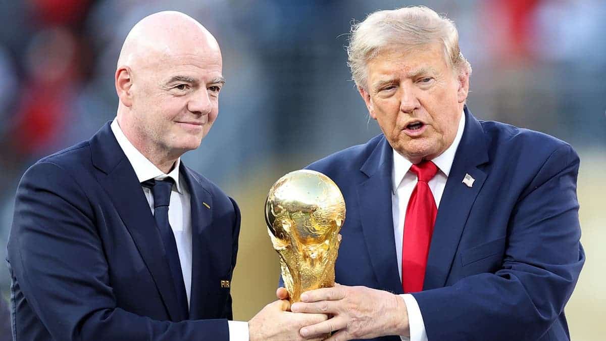 Donald Trump and Gianni Infantino hold the FIFA World Cup trophy before handing it to Spain captain Rodri.