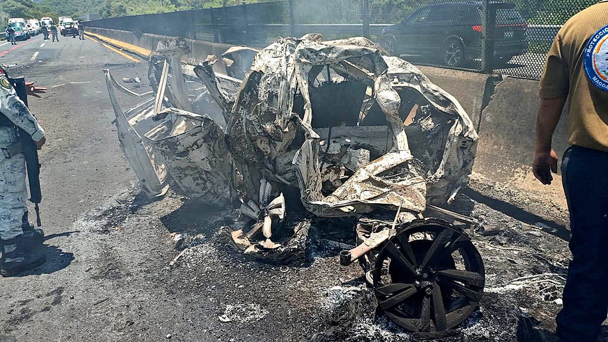 Crushed burned white car wreckage