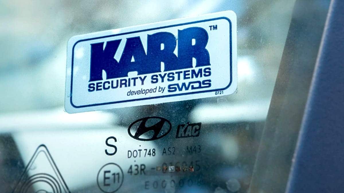 A KARR sticker is seen on the window of a car.