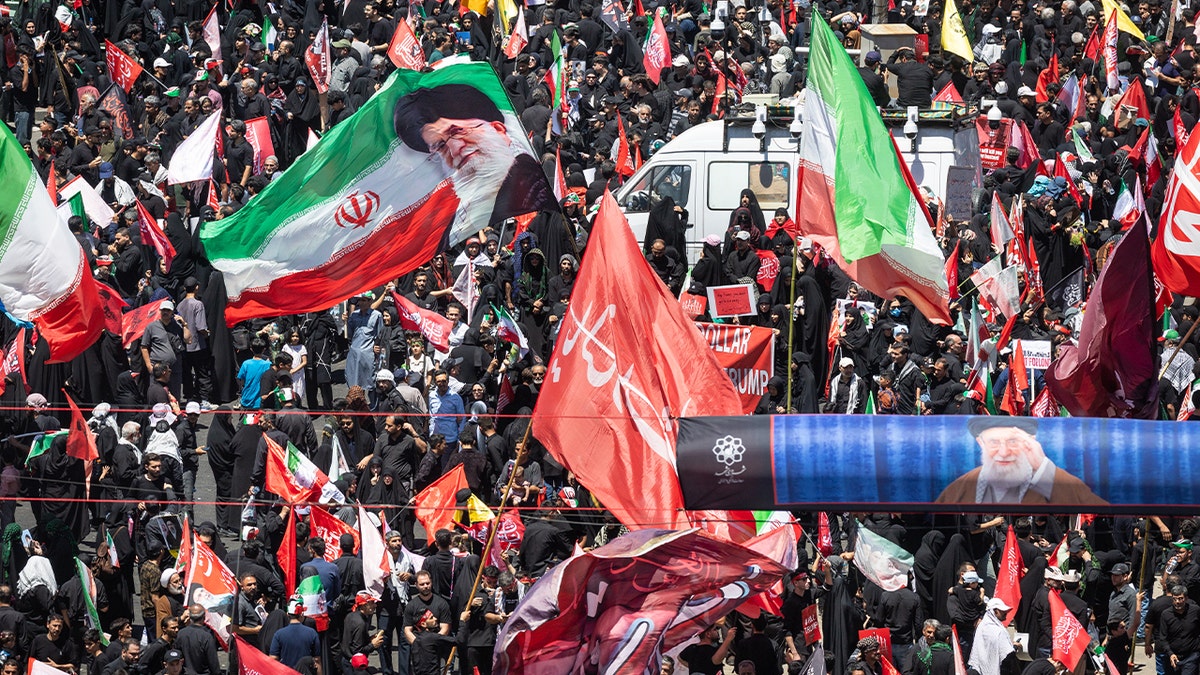 Thousands of mourners await the arrival of the body of Iran's slain Supreme Leader Ayatollah Ali Khamenei on July 09, 2026 in Mashhad, Iran.