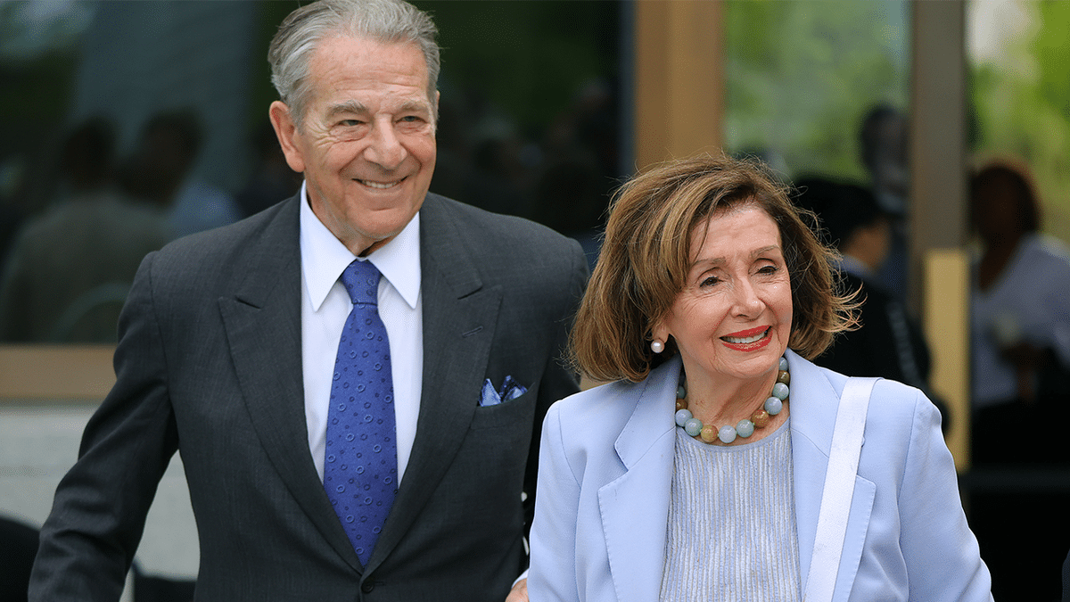 Former House Speaker Nancy Pelosi and her husband, Paul Pelosi, smile as they arrive together at an event.