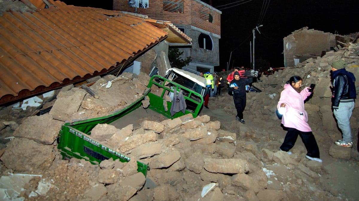 Residents walk amid debris in Pumpuya, Peru.
