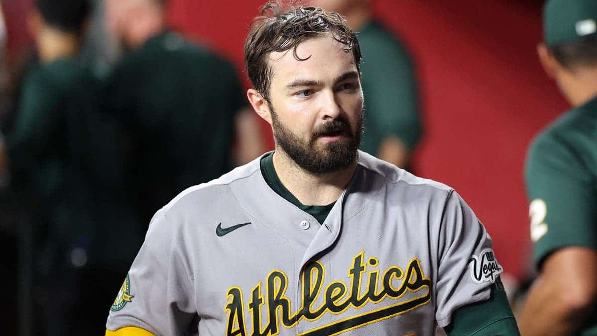 Shea Langeliers sits in the dugout after hitting a solo home run.